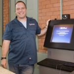 DANA PAUL of Shazamm, with one of the kiosks for which the company created software that allows companies to operate the kiosks easily and remotely. The company will complete its move to the Hope Artiste Village development in Pawtucket this month.

 

 / 