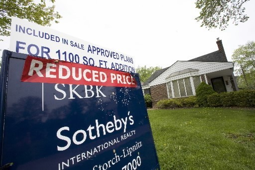 PRICES FELL in May but home sales surged 2.0% nationwide and 4.8% in the Northeast. This reduced-price sign outside a home in Birmingham, Mich., is typical of the trend. / PRICES FELL in May but home sales surged 2.0% nationwide and 4.8% in the Northeast. This reduced-price sign outside a home in Birmingham, Mich., is typical of the trend. /