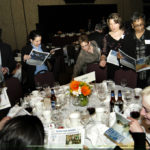 Honorees from KPMG LLP, a winner in the Medium Category, peruse the Best Places To Work supplement. / PBN Photo/Frank Mullin