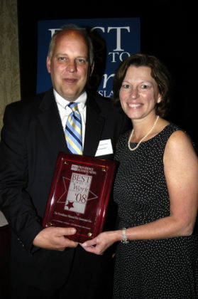 PBN Publisher Roger Bergenheim presents Sandra Parrillo, of The Providence Mutual Group, with their award for winning in the Medium Category. / PBN Photo/Frank Mullin