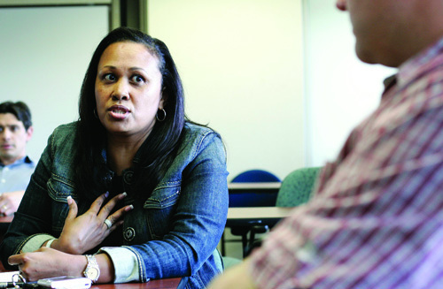 Advanced financial services Sales manager Maria Fernandes, left, discusses her management style with fellow manager Matt Sherman during a sales coaching session. / Advanced financial services Sales manager Maria Fernandes, left, discusses her management style with fellow manager Matt Sherman during a sales coaching session. /