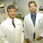 NO OVERNIGHT CESSATION: Dr. Sean David, left, and Garrett Sullivan, technology and research assistant, are examining genetics in relation to smoking. / 