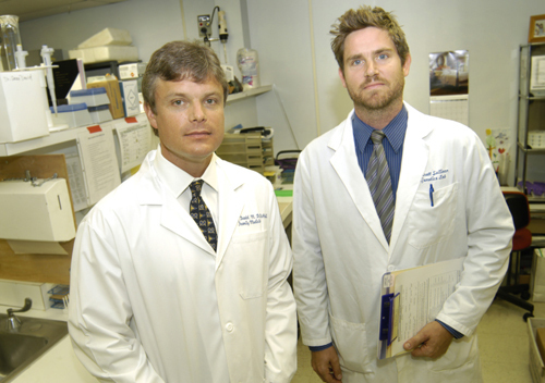 NO OVERNIGHT CESSATION: Dr. Sean David, left, and Garrett Sullivan, technology and research assistant, are examining genetics in relation to smoking. / NO OVERNIGHT CESSATION: Dr. Sean David, left, and Garrett Sullivan, technology and research assistant, are examining genetics in relation to smoking. /