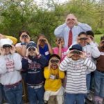 STUDENTS FROM Sullivan Elementary School in Newport pose with Thomas W. Kelly, president and CEO of BankNewport, before their educational hike through the Norman Bird Sanctuary in Middletown.  / 