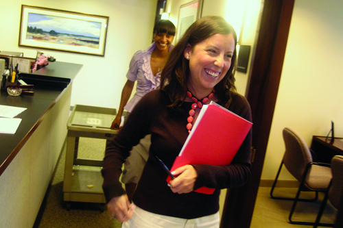 FACILITIES COORDINATOR Tracy Brooks follows Nixon Peabody attorney Elizabeth Oliveira through the halls of the firm’s Providence office in Citizens Plaza. / FACILITIES COORDINATOR Tracy Brooks follows Nixon Peabody attorney Elizabeth Oliveira through the halls of the firm’s Providence office in Citizens Plaza. /