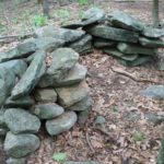THIS U-SHAPED MOUND of stones is one of hundreds found in the vicinity of the proposed Rankin Estates in North Smithfield. Some believe the mounds mark American Indian graves from more than 300 years ago. / 