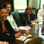 Gleda Delgado, left, laughs following a role-playing excercise at Kahn, Litwin, Renza & Co. / 