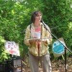 DRAWING ATTENTION: Holly Ewald, a Warwick artist, addresses a gathering this month held to raise awareness about pollution in South Providence. / 