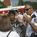 Residents of Providence&rsquo;s Lockwood Plaza celebrated a drug-free community with a block party last week that included Providence police, among them Lt. George Stamatakos. The cookout coincided with a conference held downtown on the Drug Market Intervention Initiative, the same approach used to clear the neighborhood. / 