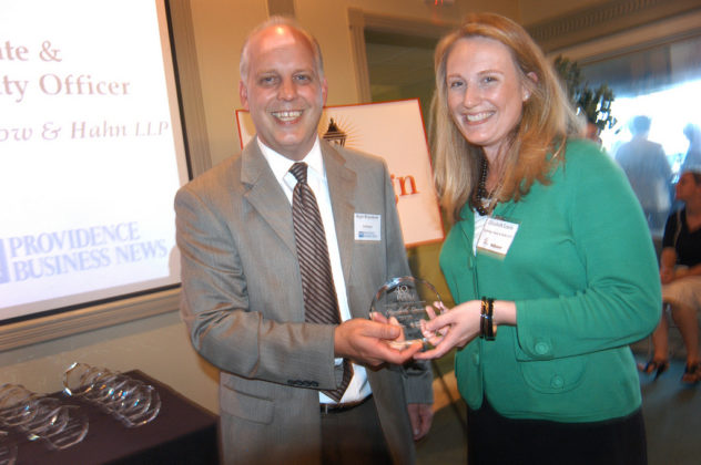 PBN Publisher Roger Bergenheim presents Honoree Elizabeth Lewis, of Partridge Snow &amp; Hahn, with her award. / PBN Photo/Frank Mullin