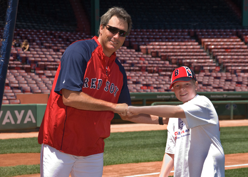 ON DECK: Dave Magadan, hitting coach for the Boston Red Sox, celebrates with 12-year-old Michael Coyne, a player on the Cumberland Challengers Little League Team, after a stint in the outdoor batting cage at Fenway Park during CVS Caremark All Kids Can Camp. / ON DECK: Dave Magadan, hitting coach for the Boston Red Sox, celebrates with 12-year-old Michael Coyne, a player on the Cumberland Challengers Little League Team, after a stint in the outdoor batting cage at Fenway Park during CVS Caremark All Kids Can Camp. /