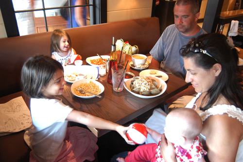 FAMILY STYLE: Trio in Narragansett, Newport Harbor Corp.’s newest restaurant, tries to appeal to children to keep business steady. Here, Barron and Jenn Anschutz eat with their daughters Melina, rear, Julia, left, and Lyla. / FAMILY STYLE: Trio in Narragansett, Newport Harbor Corp.’s newest restaurant, tries to appeal to children to keep business steady. Here, Barron and Jenn Anschutz eat with their daughters Melina, rear, Julia, left, and Lyla. /