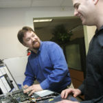 TODD KNAPP, left, president of Envision Technology Advisors, says his company is more of a business-consulting firm that specializes in technology than a traditional IT firm. With him is Mike Ando, right, a virtualization specialist. / 