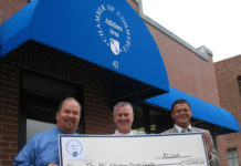MICHAEL ANDRADE, of The Arc of Northern Bristol County, center, accepts a $5,000 check from Attleboro Area Chamber of Commerce President Jack Lank, left, and 10th Annual Charity Open Golf Committee Chairman Paul Leveillee of Sovereign Bank. / 