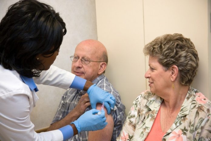 LINE OF DEFENSE: A MinuteClinic nurse practitioner gives a flu shot. MinuteClinic will offer flu shots beginning Oct. 1. / LINE OF DEFENSE: A MinuteClinic nurse practitioner gives a flu shot. MinuteClinic will offer flu shots beginning Oct. 1. /