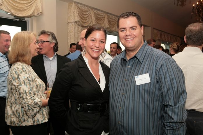Amy Briggs and Anthony Bettencourt, both of Shazamm, enjoy the evening's cocktail reception. / PBN Photo Amy Briggs and Anthony Bettencourt, both of Shazamm, enjoy the evening's cocktail reception. / PBN Photo