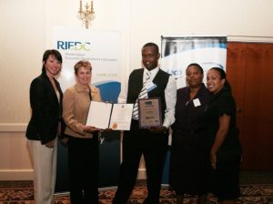 Guests from the Met School as they proudly display Jean Merlain's (center) award as the Student Innovator. / PBN Photo