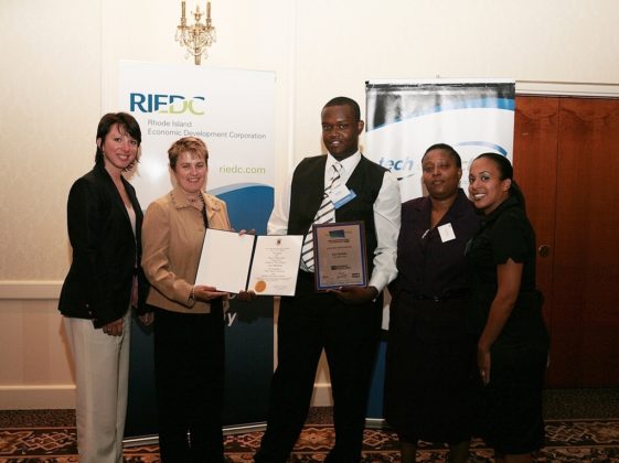 Guests from the Met School as they proudly display Jean Merlain's (center) award as the Student Innovator. / PBN Photo