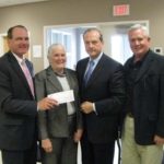 NED MCCRORY, principal at Batchelor Frechette McCrory Michael & Co.,left, presents Susan Wallace, founder and executive director of Caritas, with a check for $7,200. Also pictured are Robert Mancini, executive director of RISCPA, second from right, and Stephen Craven, senior vice president of Sovereign Bank and Caritas’ board president. / 