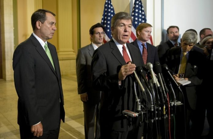 MINORITY WHIP Roy Blunt, R-Mo., speaks about the revised rescue plan at the Capitol today. Listening are fellow House Republicans, from left, John Boehner of Ohio, Eric Cantor of Virginia and Adam Putnam of Florida. / 