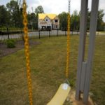 ON HOLD: An unfinished house looks next to a playground in an unfinished neighborhood in Forsyth, Ga.  / 