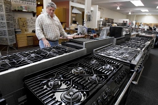 CONSUMER PURCHASES of durable goods such as cars and major appliances fell 2.9% last month, while purchases of non-durable goods fell 0.8%, the BEA said. Above, Todd Malone of Berkeley, Calif., looks at kitchen ranges this spring in the local General Appliance & Kitchen store. / CONSUMER PURCHASES of durable goods such as cars and major appliances fell 2.9% last month, while purchases of non-durable goods fell 0.8%, the BEA said. Above, Todd Malone of Berkeley, Calif., looks at kitchen ranges this spring in the local General Appliance & Kitchen store. /