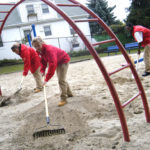City Year Rhode Island volunteers, from left, Amanda Smidt, Julie Hall, Tyree Lawson and Crystal Dragon work to clear broken glass and debris in the playground area of the Ascham Street Park in Providence’s North End. / 