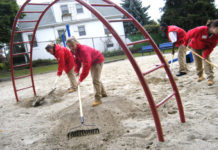 City Year Rhode Island volunteers, from left, Amanda Smidt, Julie Hall, Tyree Lawson and Crystal Dragon work to clear broken glass and debris in the playground area of the Ascham Street Park in Providence’s North End. / 