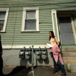 UNWELCOME SIGHT: Jessica Lang, left, and Kari Lang stand in front of 263 Carpenter Street, where gas meters have been put on the front of the house. / 