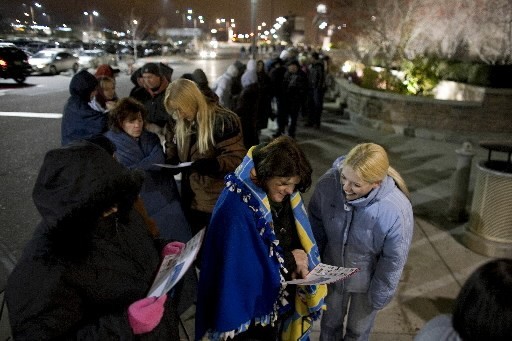 EARLY BIRDS: Doorbuster shoppers check ads this morning in Thornton, Colo., where they braved the pre-dawn chill to be first in the door at their local Super Target store. / EARLY BIRDS: Doorbuster shoppers check ads this morning in Thornton, Colo., where they braved the pre-dawn chill to be first in the door at their local Super Target store. /
