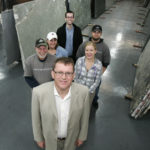 Barry Eyre, front, managing partner of Saint John Stone, stands with staff members, clockwise from left, Frank Eley, Angel Elston, Andrew Hobby, Brian Lapore and Jessica Carter, inside the company warehouse. / 