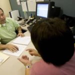 When owning a home forces borrowers ‘underwater’ HOPE FLOATS: Rhode Island Housing Homeownership Assistance Specialist Rodrigo Betancur helps a client in a
counseling session last week. /