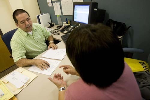 HOPE FLOATS: Rhode Island Housing Homeownership Assistance Specialist Rodrigo Betancur helps a client in a
counseling session last week. / HOPE FLOATS: Rhode Island Housing Homeownership Assistance Specialist Rodrigo Betancur helps a client in a
counseling session last week. /