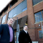 COMMUNITY DEVELOPMENT: Attleboro Redevelopment Agency Director of Project Management Ron Dubuc, left, and ARA Executive Director Michael Milanoski tour a Pearl Street building that will be used for jewelry manufacturing. / 