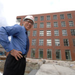 LONG TIME COMING: URI College of the Environment and Life Sciences Dean Jeff Seemann stands outside the soon-to-be-finished Center for Biotechnology & Life Sciences. / 