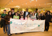DISHING IT OUT: Students from the Wolf School in East Providence pose with Boston Celtics’ point guard Rajon Rondo during the Shaw’s Supermarket “Spirit of Giving” kick-off. The students, who are also conducting a holiday food drive for the Rhode Island Community Food Bank, created a banner to thank Rondo for his own efforts to help those less fortunate. / 