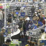 BLACK FRIDAY: Consumers, such as these at Best Buy in Warwick the day after Thanksgiving, exceeded retailers’ expectations for the early holiday-shopping rush. However, most store owners are not expecting banner sales the rest of the season. / 