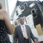 VACANT PROPERTIES that have been vandalized create not just an eyesore but a danger to local children, contends Providence City Councilor Terrence M. Hassett, shown this summer outside a damaged house in Smith Hill. (READ MORE) / 