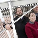 LET THE SUNSHINE IN: John Jacobson, left, Connie McGreavy and Mark DiPetrillo, members of the Rhode Island chapter of the U.S. Green Building Council, stand in front of a vacuum tube solar collector on top of Jacobson&rsquo;s mixed-use building on Wolcott Street. / 