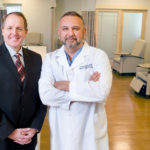 KENNETH H. BELCHER, president and CEO of Roger Williams Medical Center, and Dr. N. Joseph Espat, interim director of the hospital’s cancer center, pose inside the facility. / 