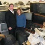 NEW LIFE: Thurston J. Hartford, president and CEO, left, and Susan Hartford, director of human resources, stand amid televisions and computer monitors collected by Ewaste Technology Management. / 