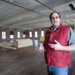 BUILDING SOMETHING: AVTECH Software CEO Michael Sigourney shows off the company’s new headquarters, a soon-to-be-renovated mill in Warren. /