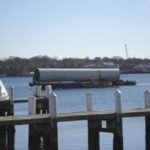 BON VOYAGE: The barge bearing the wind turbine heads from Quonset Point to Newport, where the turbine sections were offloaded to embark on the final leg of their journey to Portsmouth, via flatbed truck. / 