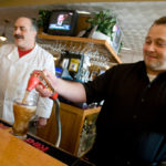 Balancing family, work proves a daily challenge ISLAND MAINSTAY: Peter Krones, left, and Chris Keefe, co-owners of The Mainstay Restaurant in Newport, work behind the bar at the restaurant. /
