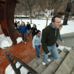 LEO PERRONE leads a group of fellow GTECH Corp. employees on a lunchtime walk along the Providence River. / 