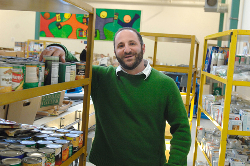 BANKING ON SUPPORT: Michael Cerio, Rhode Island Community Food Bank spokesman, said that the amount of people the
nonprofit serves has increased while support from state government and the food-service industry has dropped recently. / BANKING ON SUPPORT: Michael Cerio, Rhode Island Community Food Bank spokesman, said that the amount of people the
nonprofit serves has increased while support from state government and the food-service industry has dropped recently. /