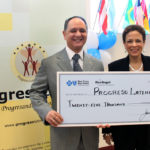 Linda Newtwon, vice president of diversity & community relations at Blue Cross & Blue Shield of Rhode Island, presents a donation of $25,000 to Ramon Martinez, president and CEO of Progreso Latino, for the Blue Health Angels Program