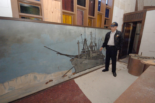 PAINTING A PICTURE: Jim Rugh, vice president of the Seabee Museum & Memorial Park, looks at a mural depicting Seabees unloading supplies at a station in Antarctica. / PAINTING A PICTURE: Jim Rugh, vice president of the Seabee Museum & Memorial Park, looks at a mural depicting Seabees unloading supplies at a station in Antarctica. /