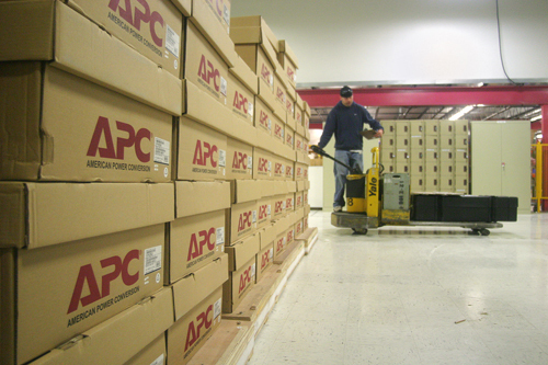 TRICKS OF THE TRADE: APC by Schneider Electric, a division of France-based Schneider Electric, is one of many Rhode Island businesses active in global trade. Above, a worker at the company’s South Kingstown plant. / TRICKS OF THE TRADE: APC by Schneider Electric, a division of France-based Schneider Electric, is one of many Rhode Island businesses active in global trade. Above, a worker at the company’s South Kingstown plant. /