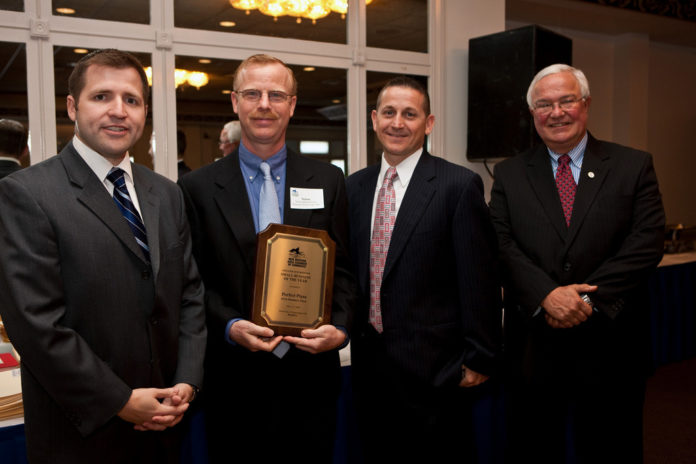 NELSON HOCKERT-LOTZ, second from left, owner of Perfect Pizza Inc., accepted the 2009 Greater New Bedford Small Business of the Year Award at an event earlier this month. He is shown with, from left, Roy Nascimento, president and CEO of the New Bedford Area Chamber of Commerce; James R.  Pratt, managing partner at Hodgson Pratt & Associates; and Thomas F. Lyons, president and CEO of BankFive. / 